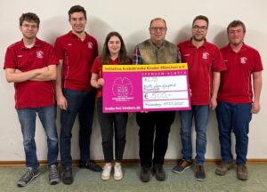 5 Männer und eine junge Frau zeigen den Spendenscheck
